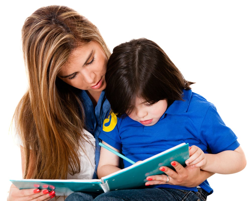 Boy coloring a book with his mother - isolated over white background