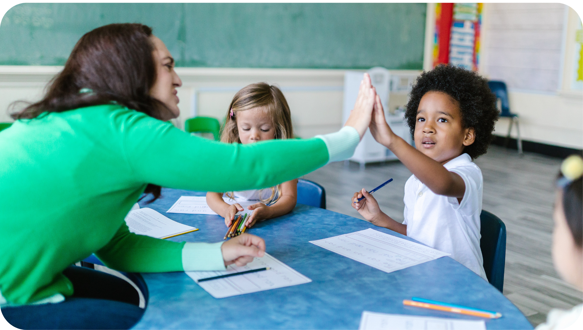 teacher interacting with student in the classroom 