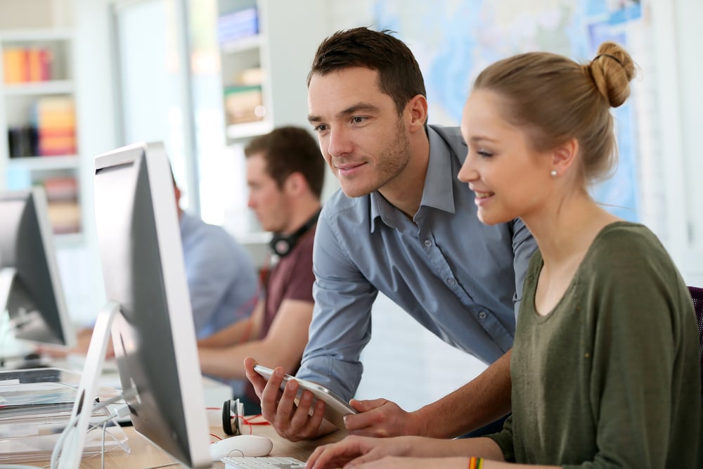 Professor working with a student in the computer