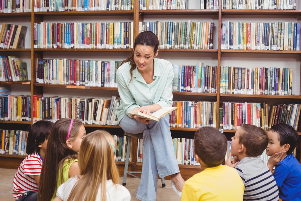 Teacher reading her pupils a story at the elementary school-1